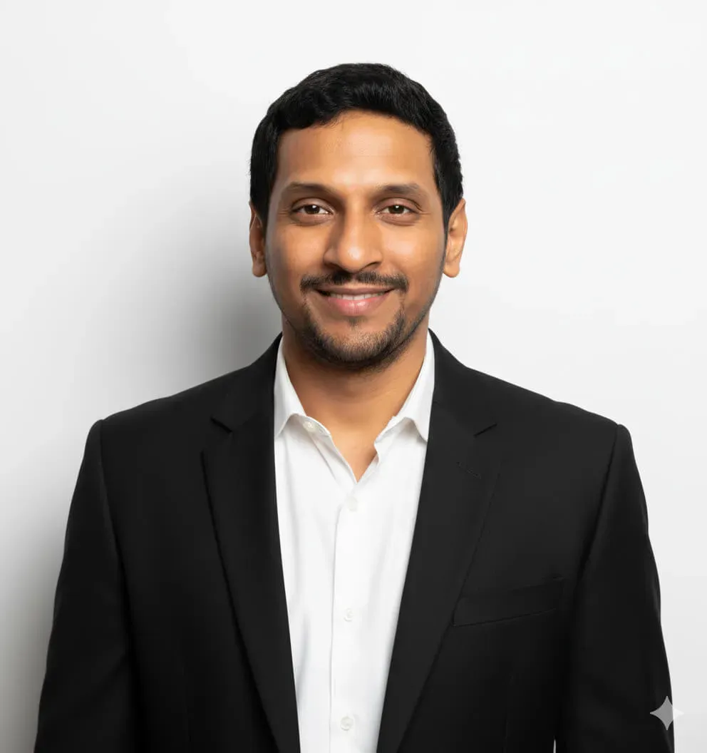 A person wearing a black blazer over a white dress shirt with an open collar. Image generated using Nano Banana.